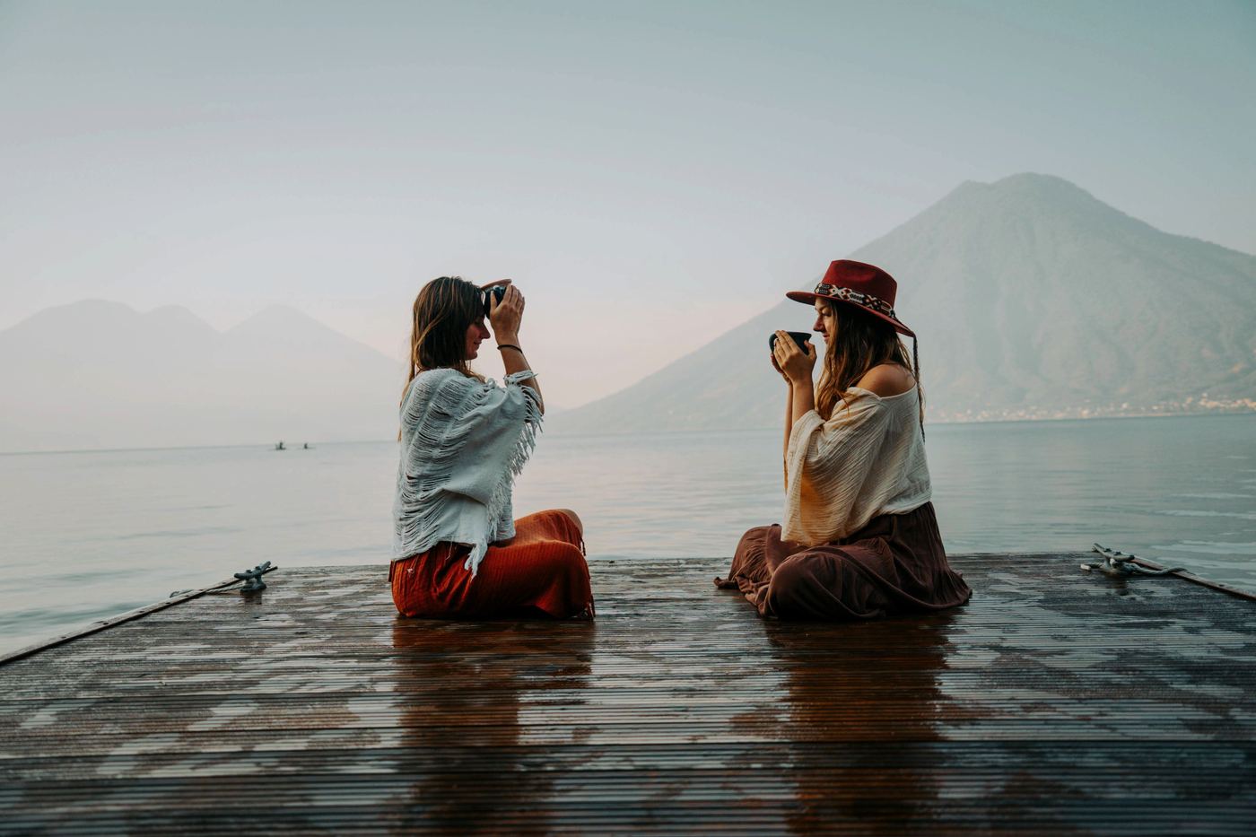 Anya and Laura, the founders of Volcano Spirit Cacao, on a dock at Lake Atitlán