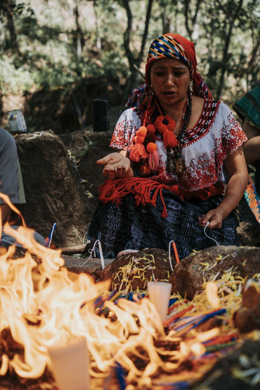 A Mayan woman leading a fire ceremony