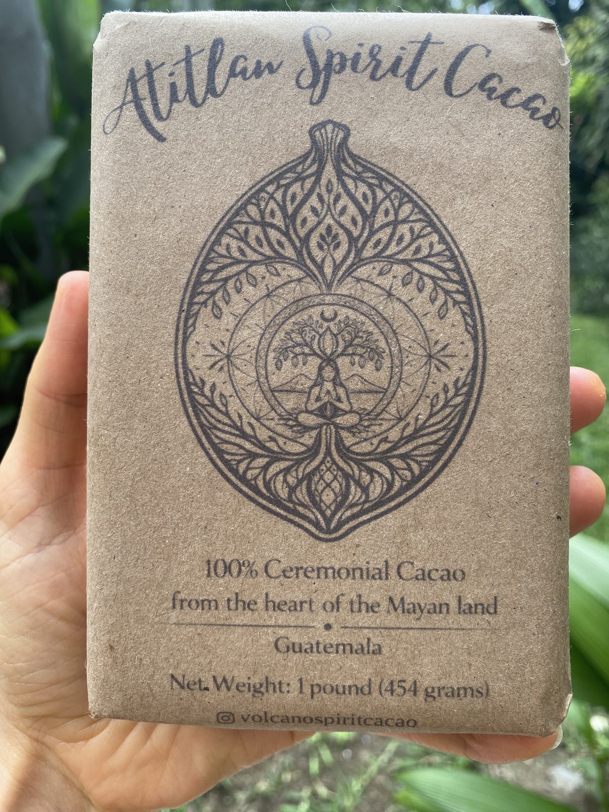 A 454g block of Volcano Spirit ceremonial cacao held in hand
